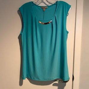 Shirt more light green than blue